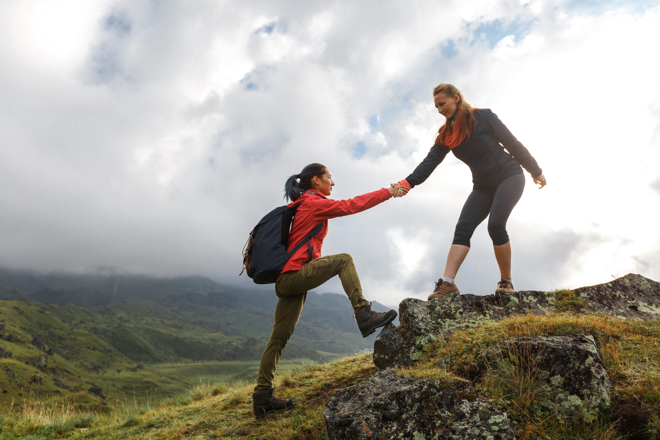 One mountain climber helps another