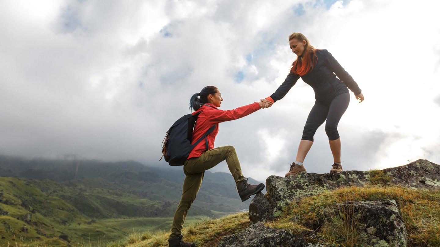 One mountain climber helps another