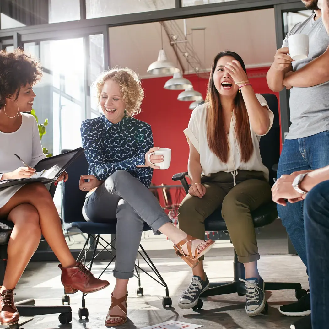 Students in a circle chatting and laughing