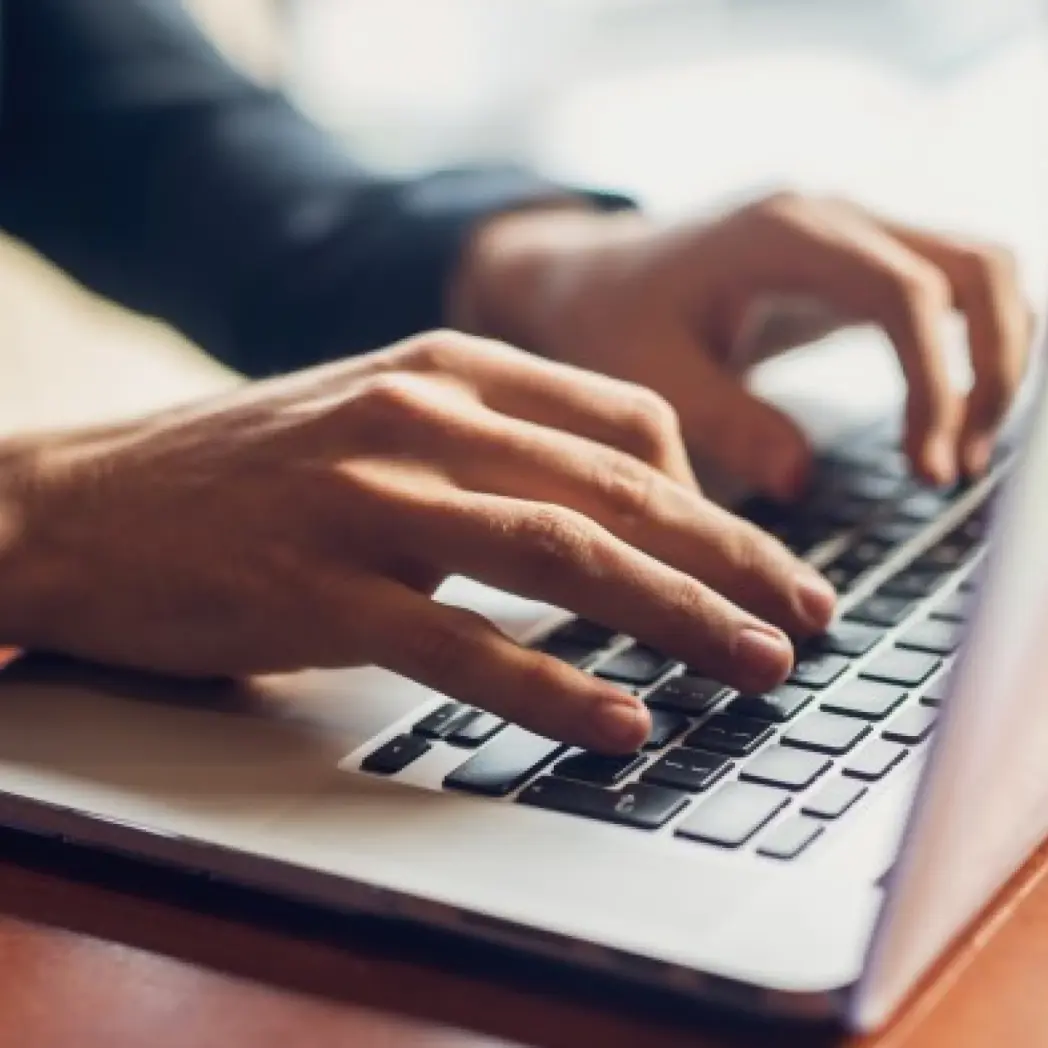 Typing on a laptop