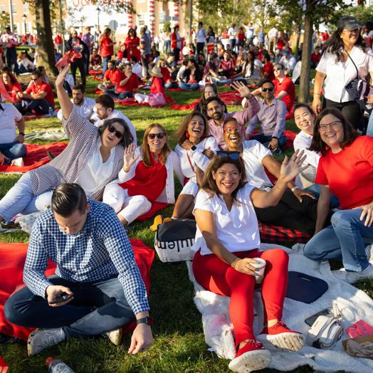 J&J employees sitting outside on a grassy field