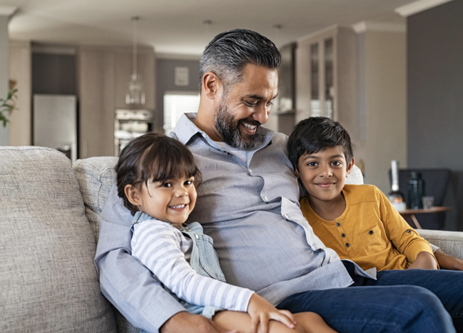 A happy father with his two kids at home