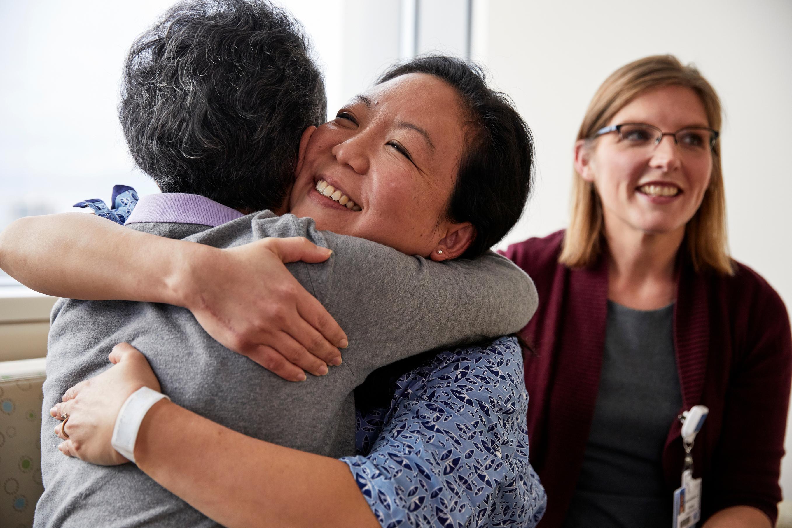 Smiling Patient And Family Embrace