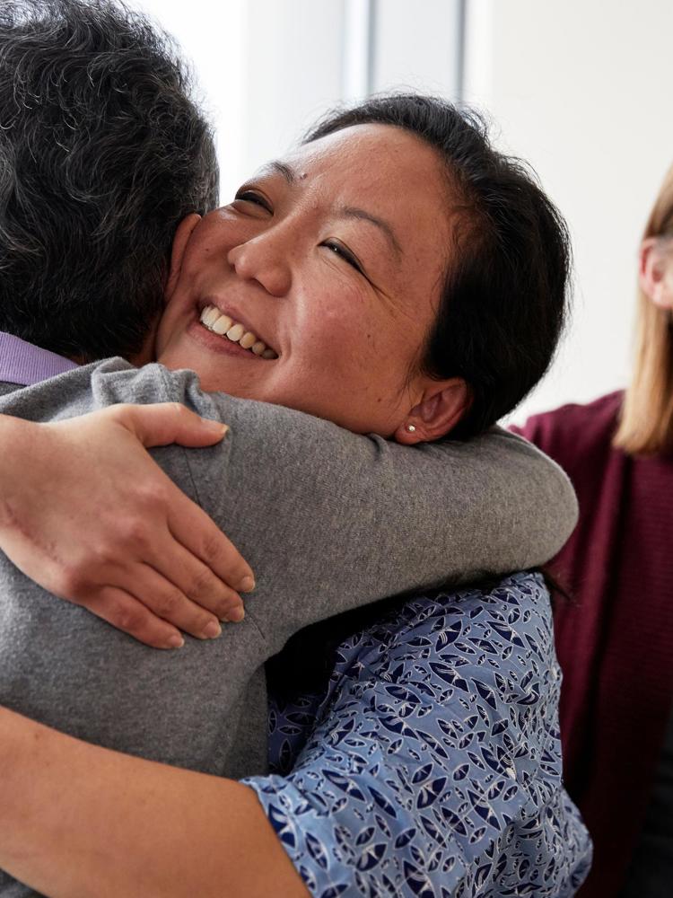 Smiling Patient And Family Embrace