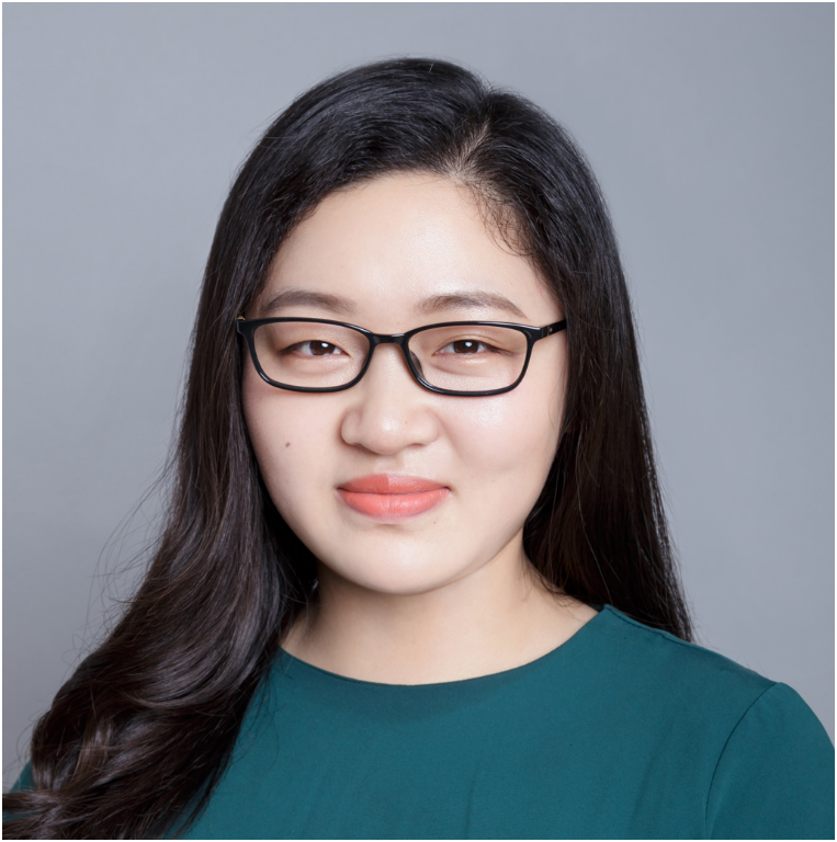 A headshot of an Asian woman wearing a long-sleeved teal top and glasses