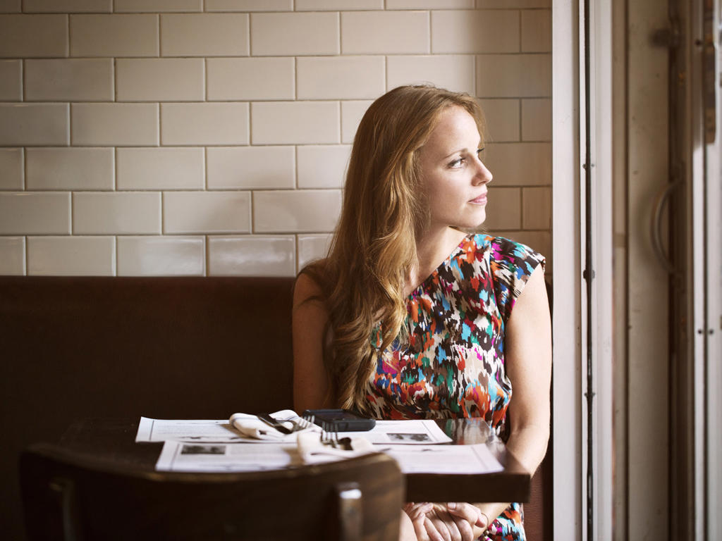 Woman In Cafe Looking Out Window