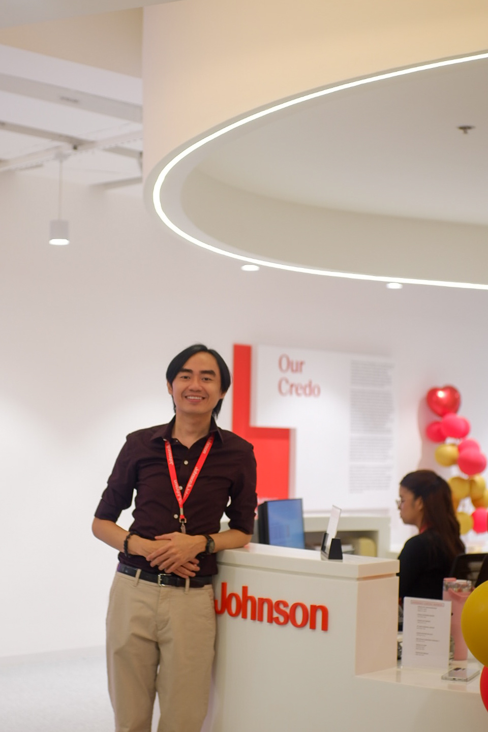 A man stands in front of the lobby desk at J&J Manila