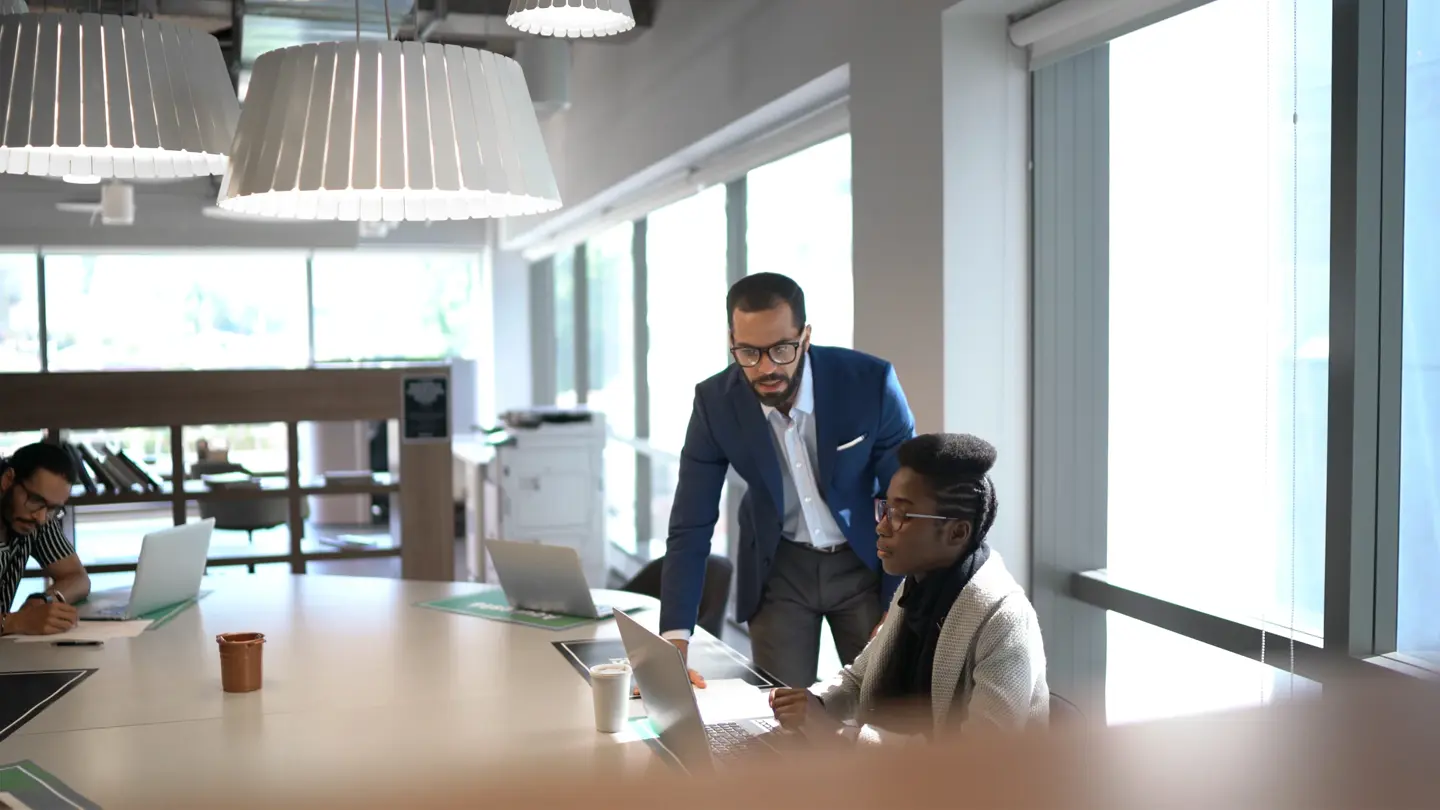 Colleagues in conversation in an office or professional setting