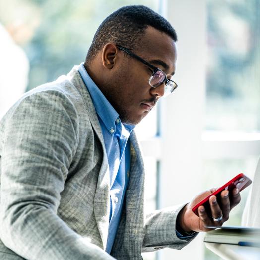 A man looking down at his mobile device