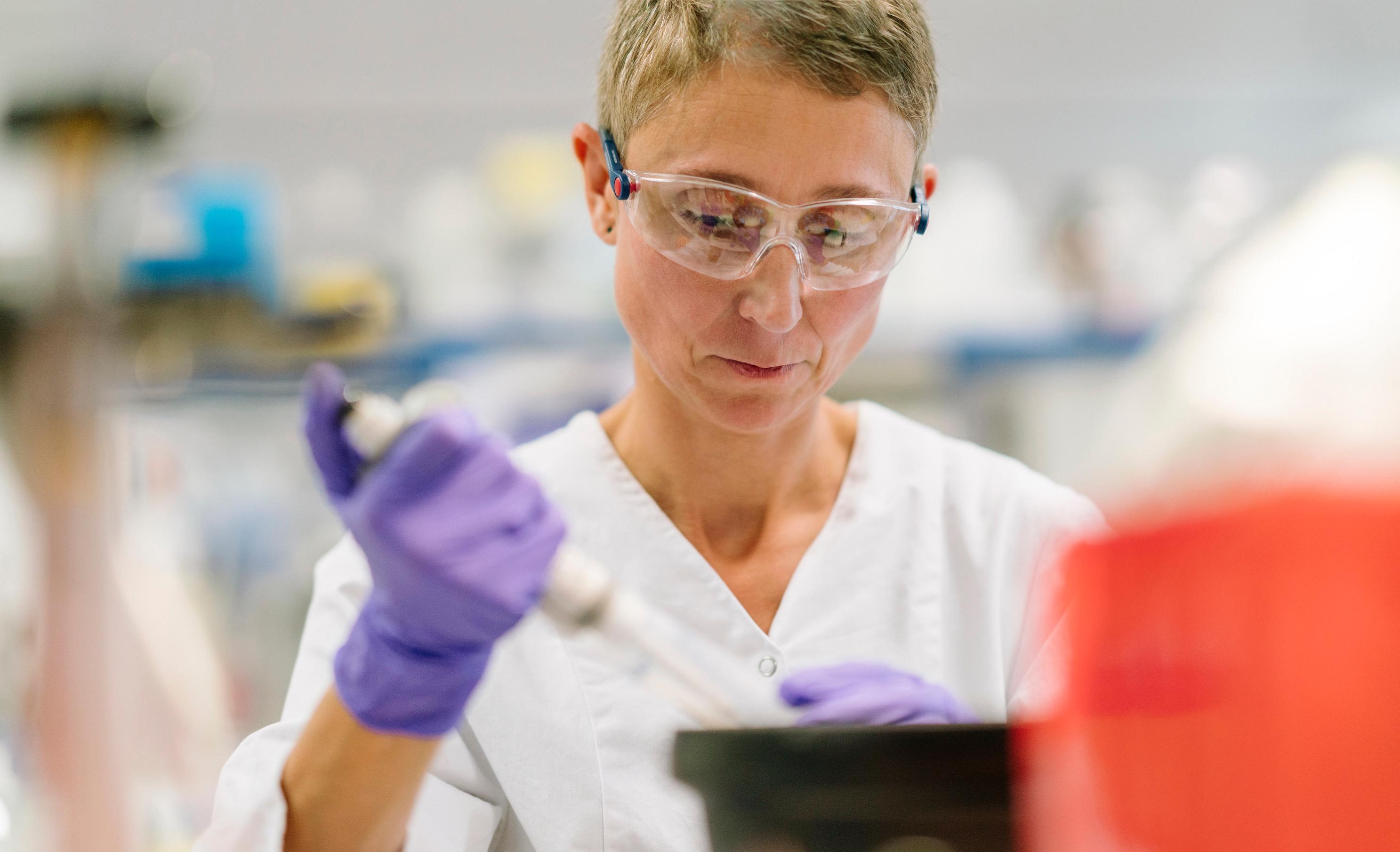 JJ Photo Scientist Holding Lab Instrument IM 4Star