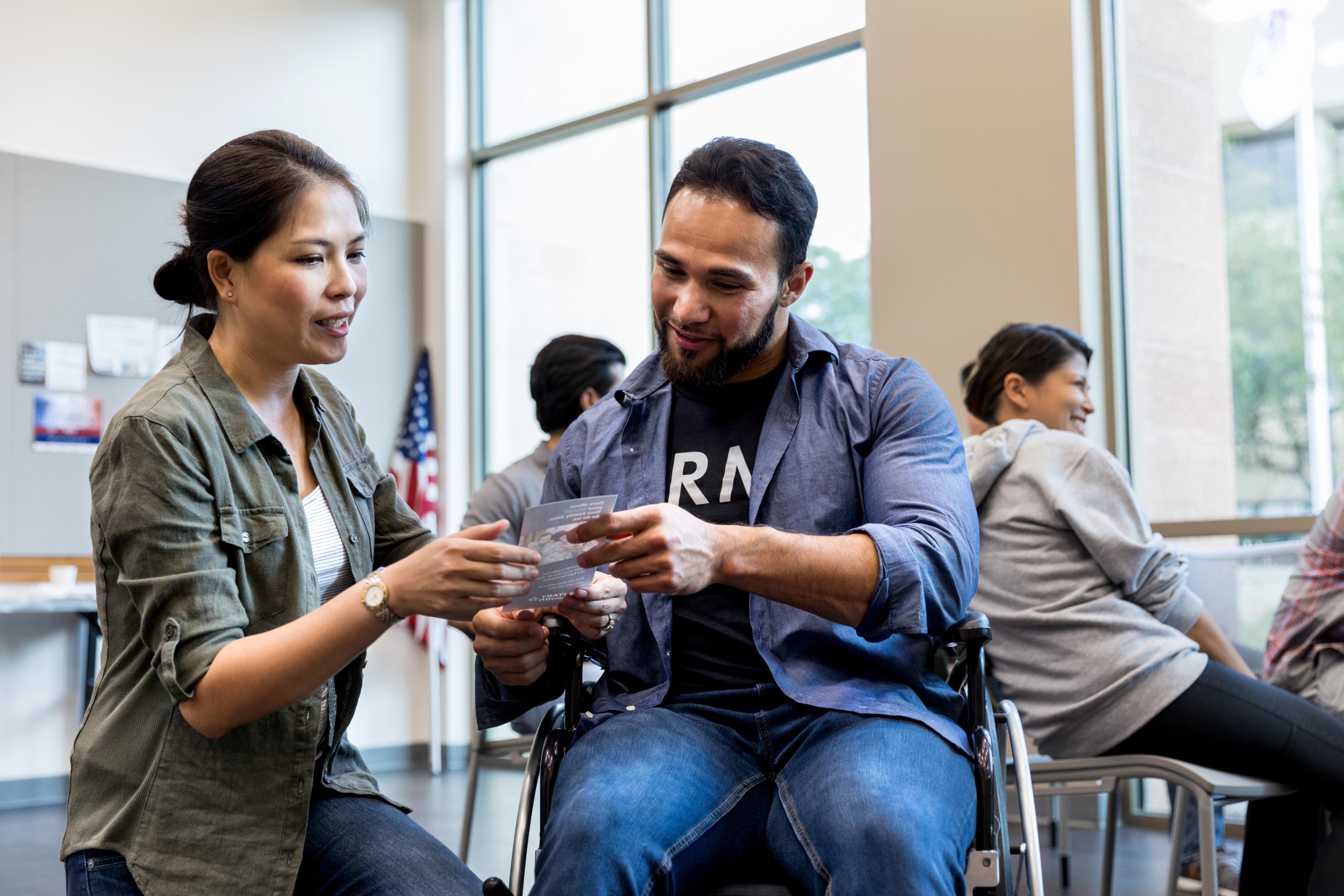 Military Veteran Receiving An Informational Handou
