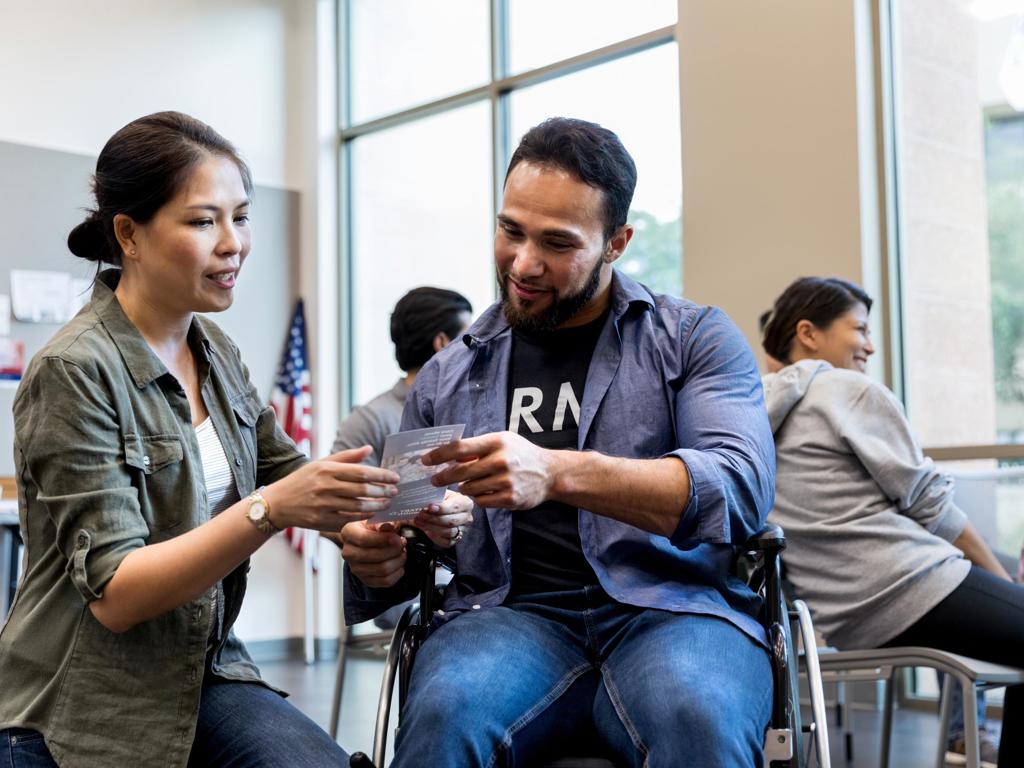 Military Veteran Receiving An Informational Handou