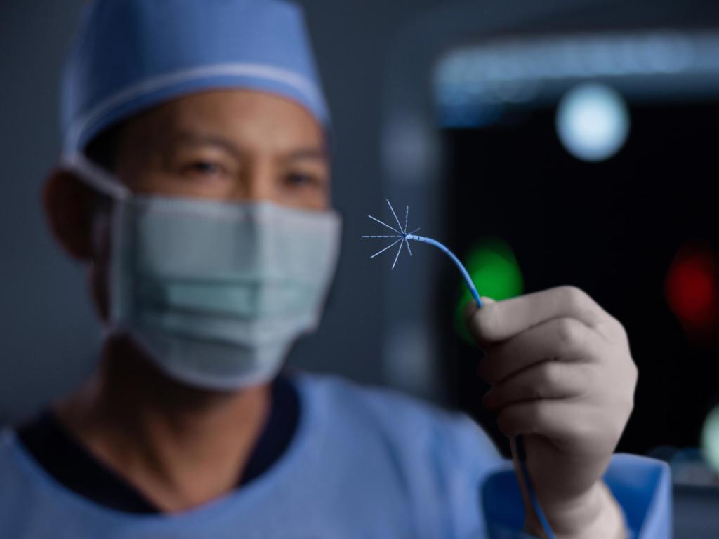 A physician holding a J&J MedTech device