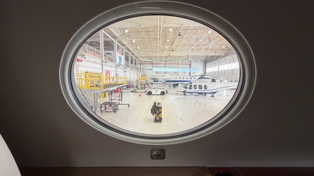 View of the hangar at J&J Aviation seen through an airplane window