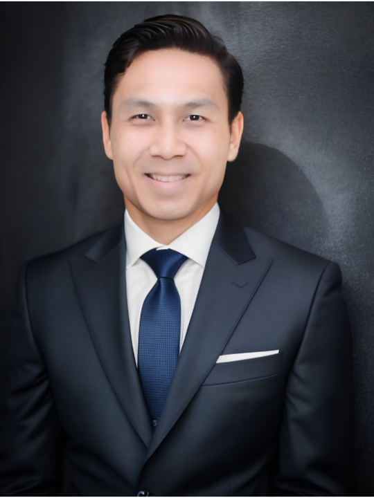 A portrait of a man in a dark suit