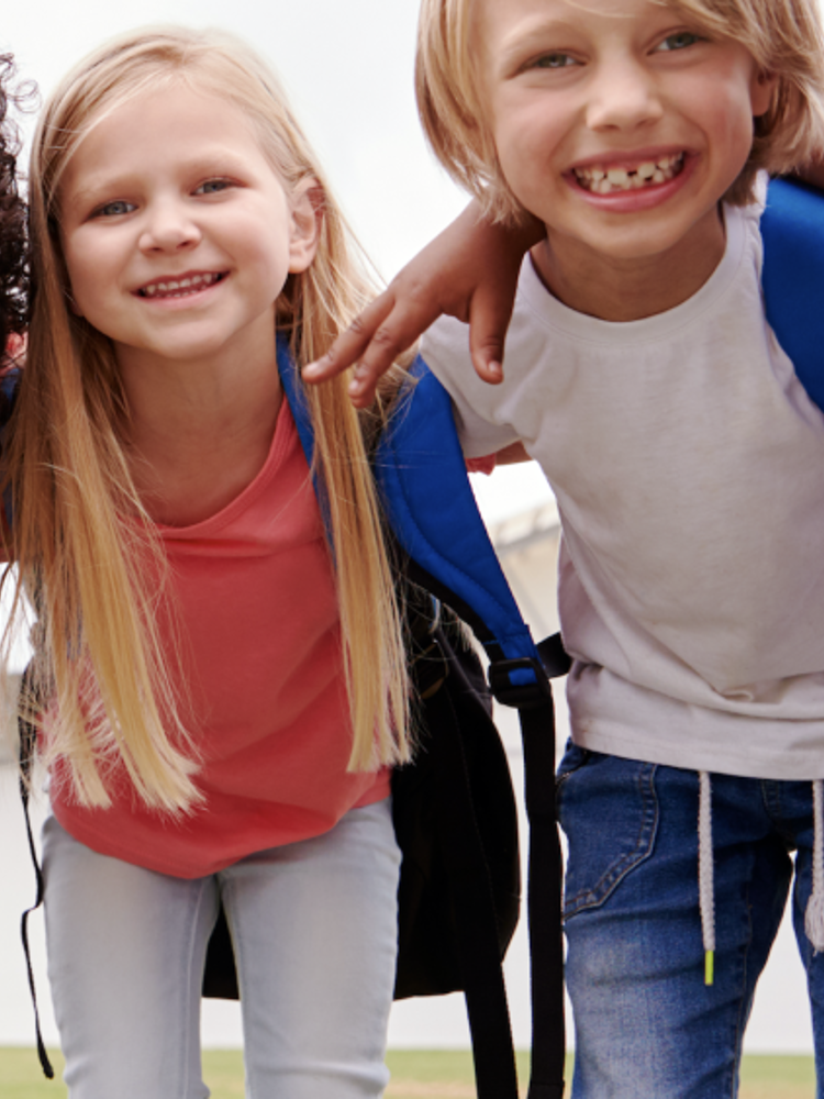 Group of young children hugging outside