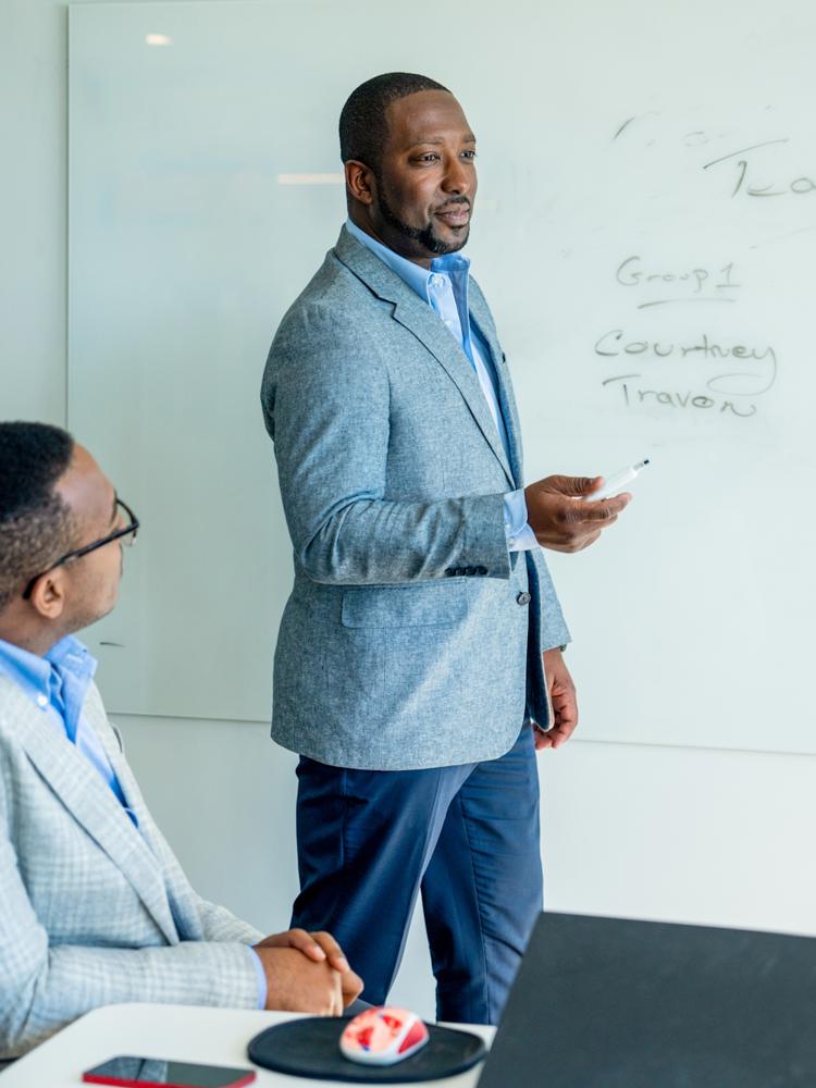 J&J leader speaking while whiteboarding