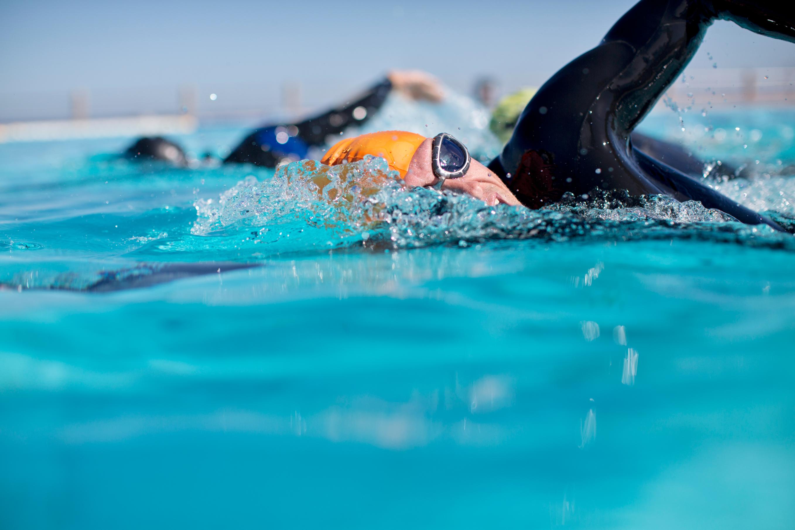 Triathletes In Wetsuit Splashing In Pool