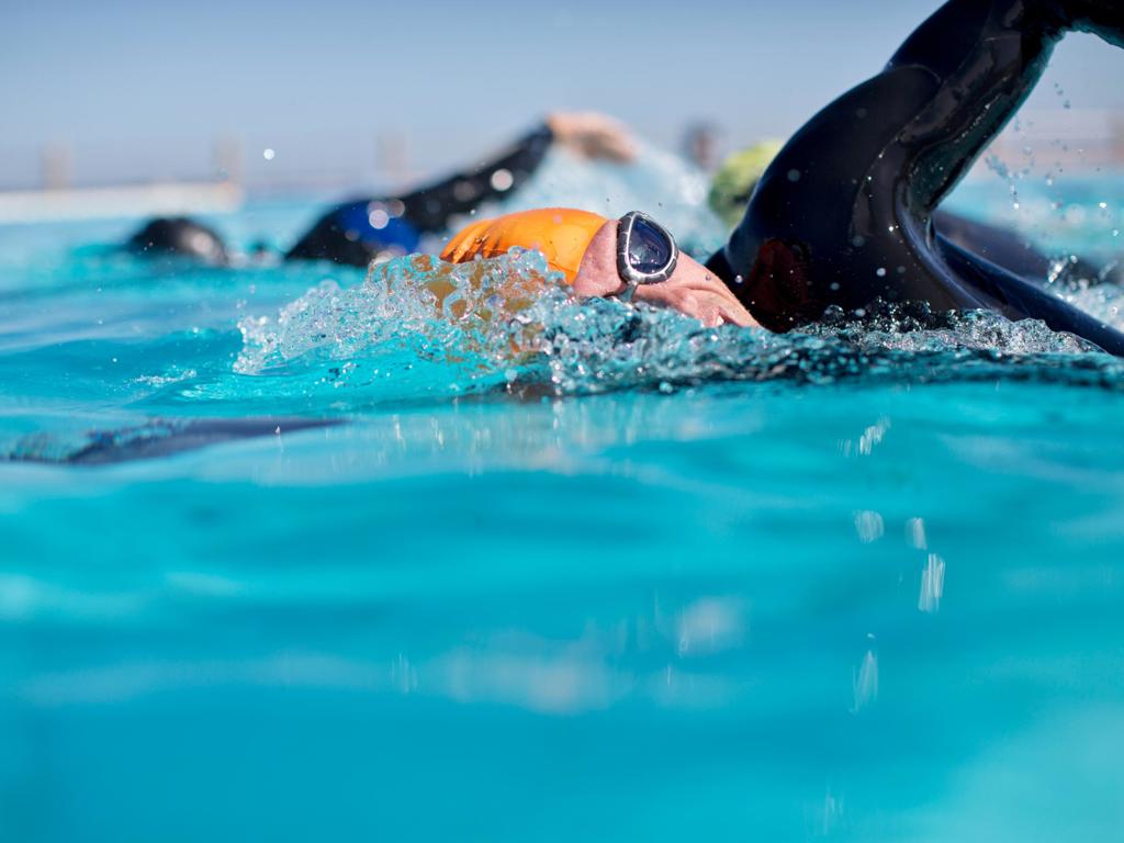 Triathletes In Wetsuit Splashing In Pool