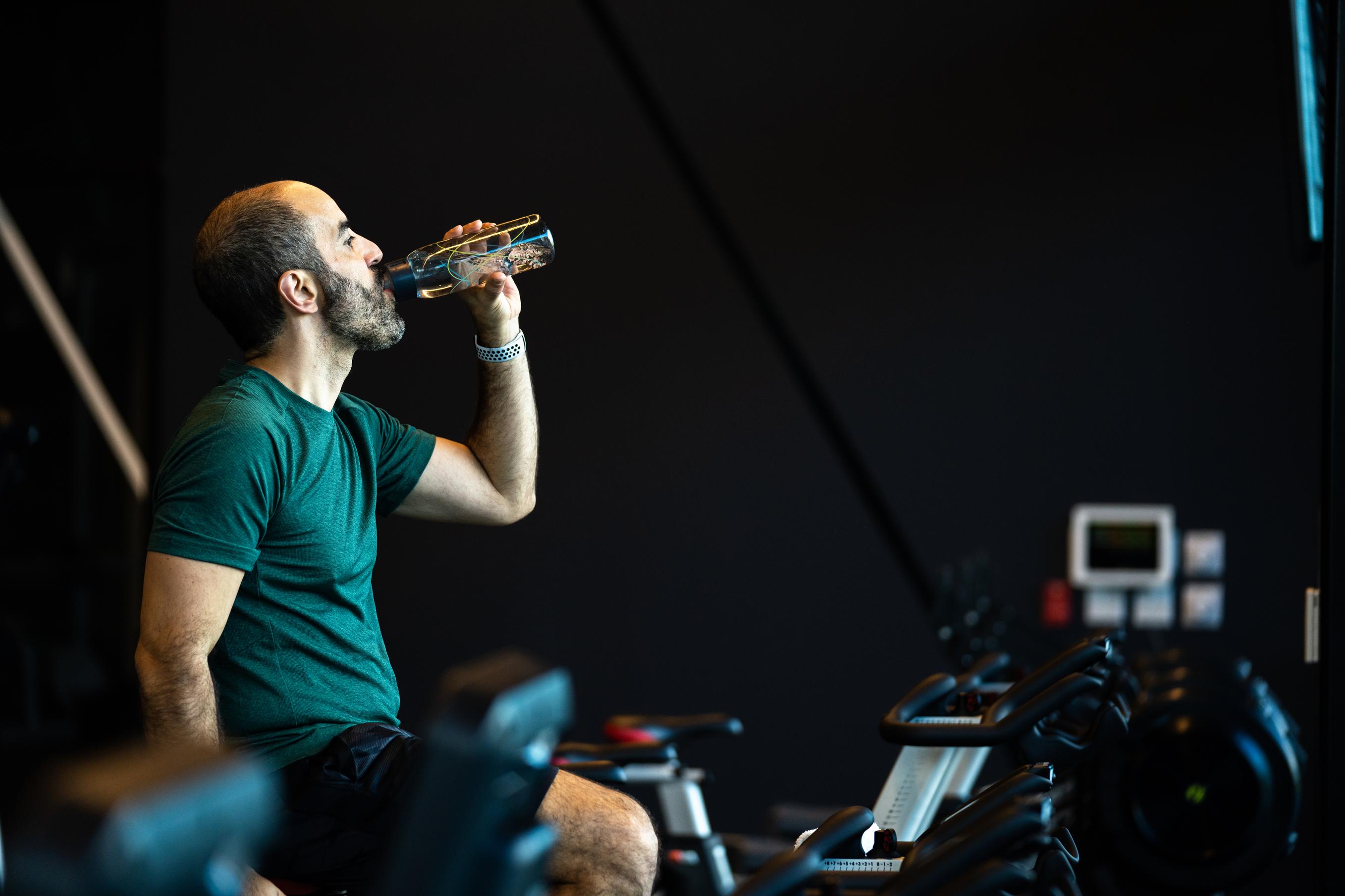 Man Drinking Water While Exercising