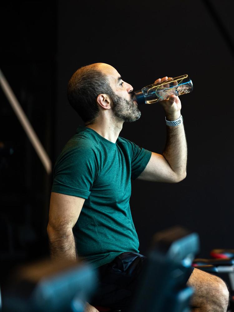 Man Drinking Water While Exercising