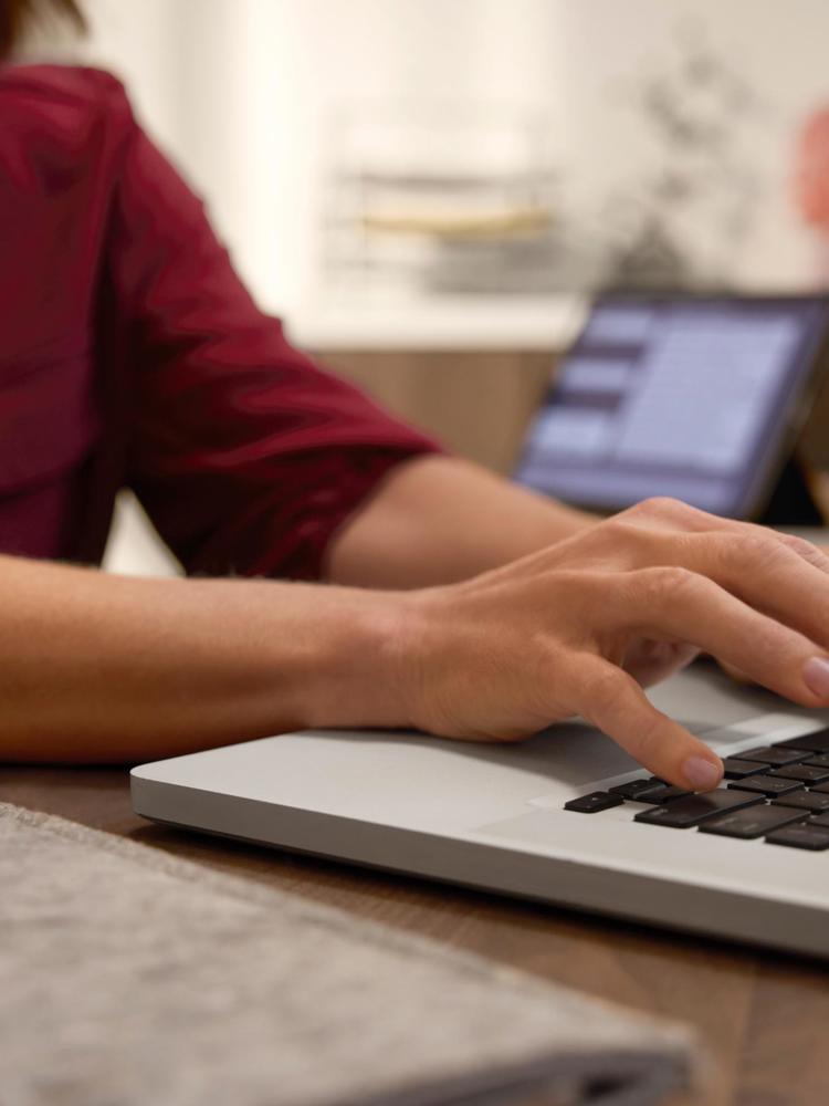 A woman typing on a laptop