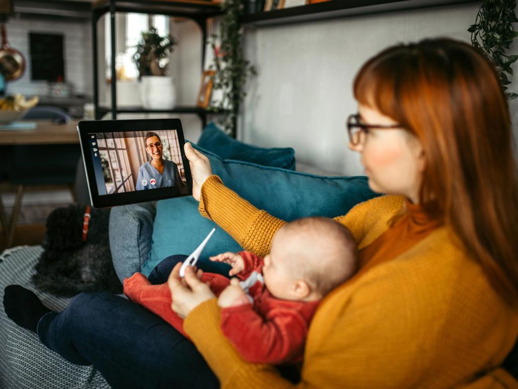 Woman consulting with pediatrician over video call