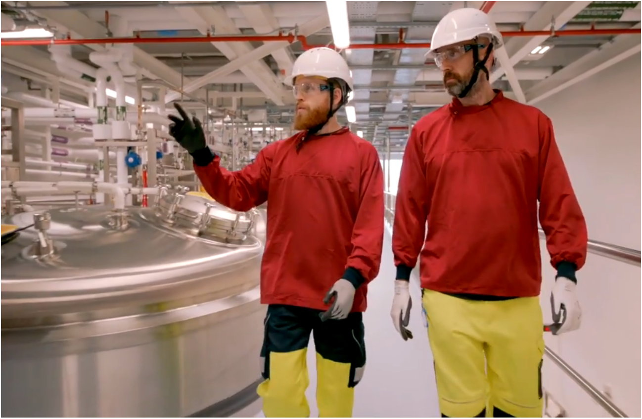 Two manufacturing technicians inspect equipment.